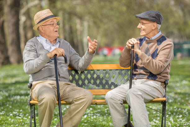 istock Two seniors talking to each other in park 522648840
