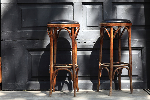 Two vintage wooden bar stools in the pub