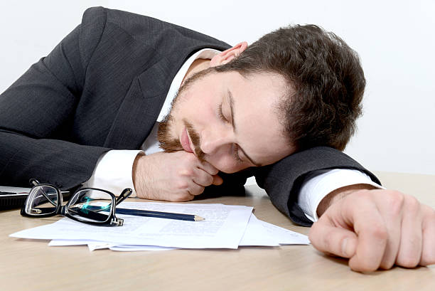 istock Young businessman sleeping on the office desk 522650117