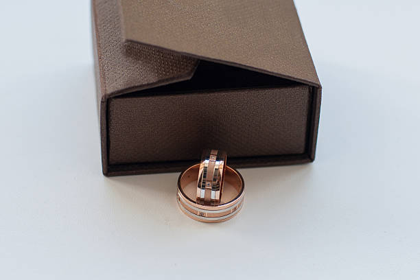 istock gold wedding rings near gift boxes 522669611