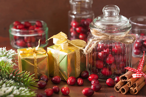 fresh cranberry in glass jars, winter decoration and gifts