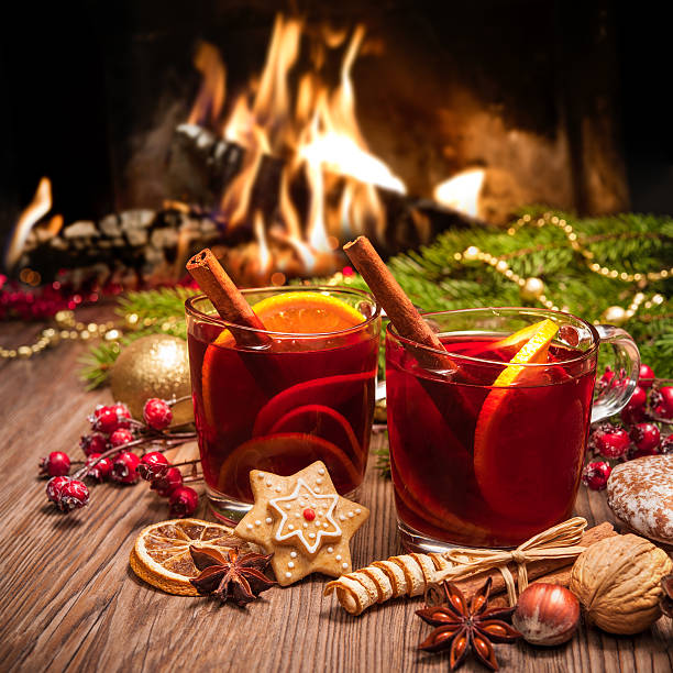 Mulled wine Two glasses of  mulled wine with christmas decoration at romantic fireplace mulled wine photos stock pictures, royalty-free photos & images
