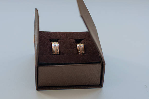 istock gold wedding rings near gift boxes 522670677