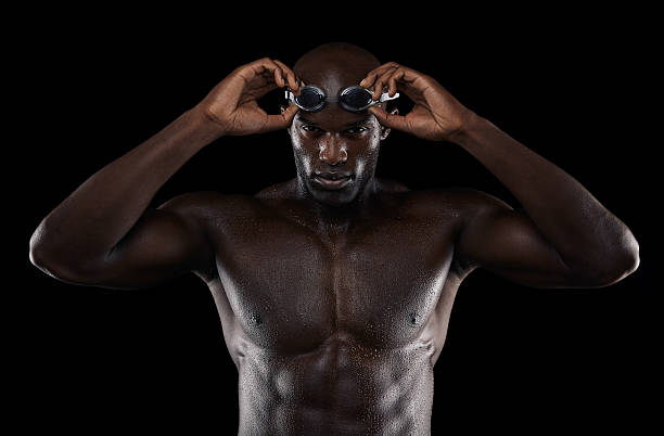 istock Young muscular swimmer with goggles 522670679