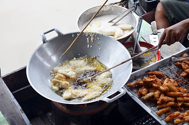 istock Cooking deep fried sliced banana thai style on boat 522673103