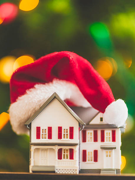 istock House with Santa cap in front of Christmas tree 522673303