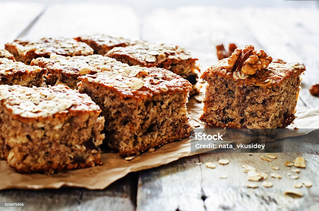 oatmeal cake with dates and walnuts oatmeal cake with dates and walnuts on a dark wood background. tinting. selective focus on walnut Baked Pastry Item Stock Photo