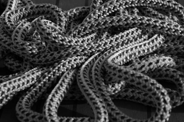 Detail of an untidy pile of nautical mooring rope on a boat deck.