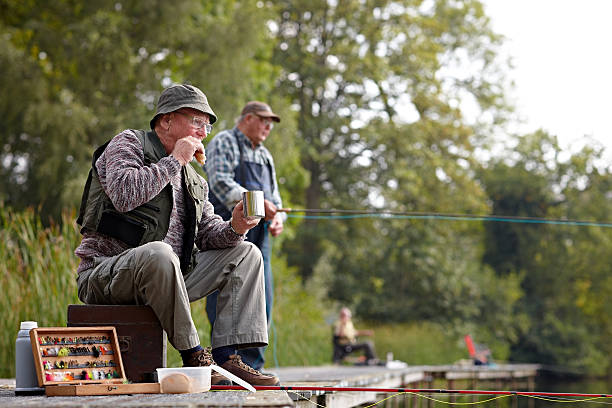 Senior fisherman having lunch