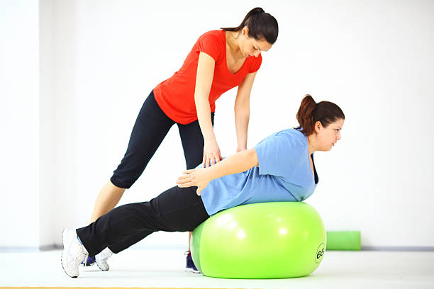 istock Women exercising in gym. 522675321