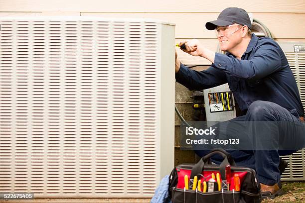 Air Conditioner Repairman Works On Home Unit Blue Collar Worker Stock Photo - Download Image Now