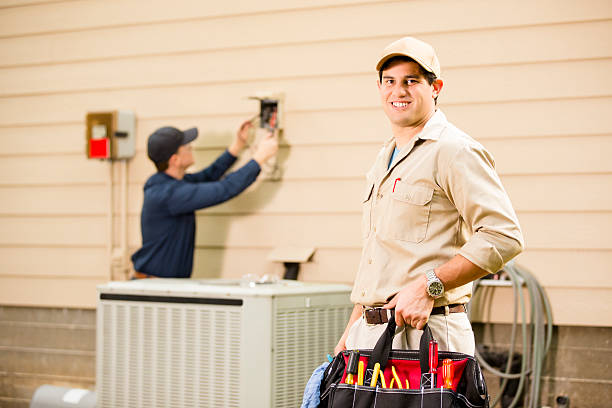 istock Air conditioner repairmen work on home unit. Blue collar workers. 522675481