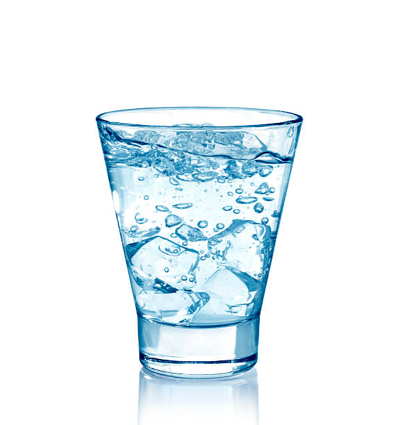 istock Ice cubes splashing into glass of water 522676805