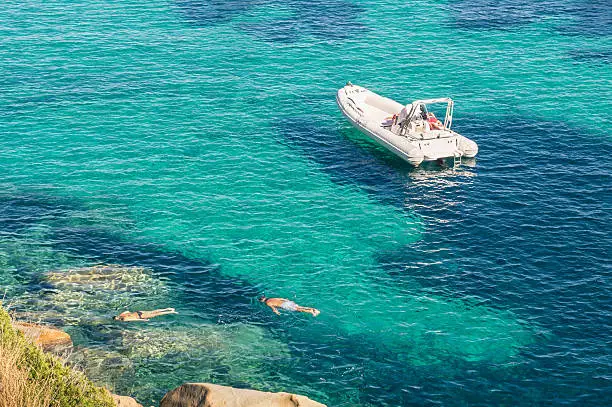 Photo of Modern luxury dinghy on turquoise sea with clear blue water