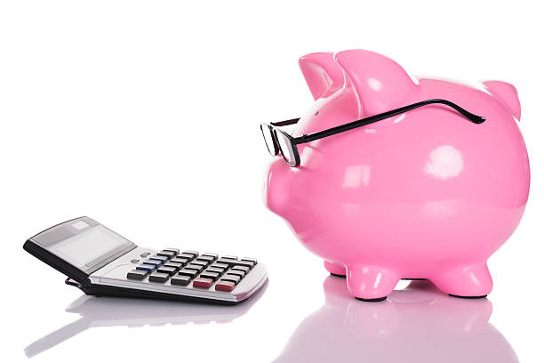 istock Piggybank looking at calculator 522690223