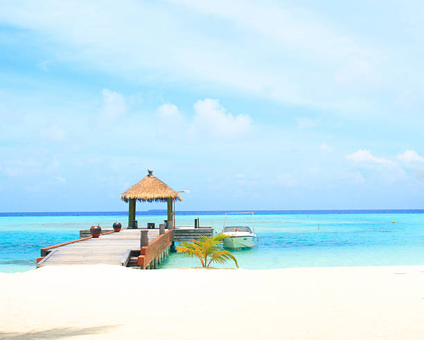 istock Overwater villas in blue tropical lagoon 522690893