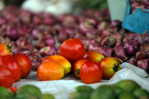 Fresh produce for sale at an open-air market in Bajawa. Vendors serve customers from their makeshift stalls in the central Flores town.