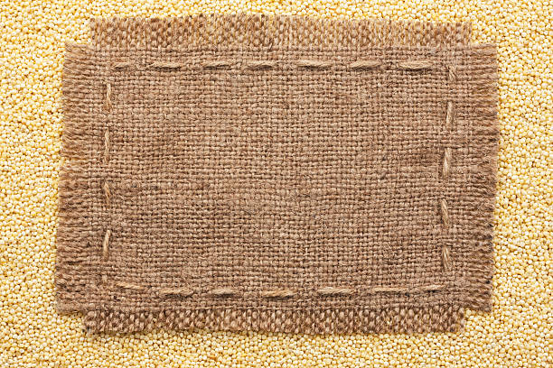 istock Frame of burlap  lying on a millet  background 522691891