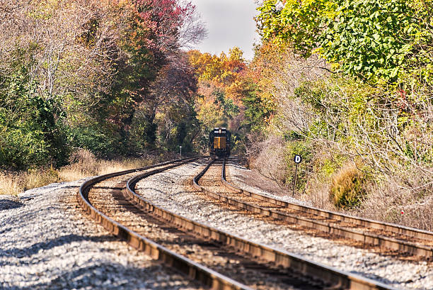 istock Train on railroad tracks in rural autumn landscape 522692301