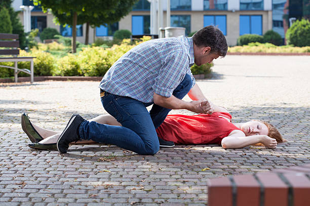 istock Man trying to help unconscious woman 522693835