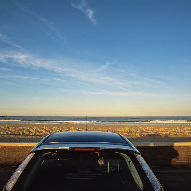 istock Blue car parked at sea under a deep blue sky 522693839