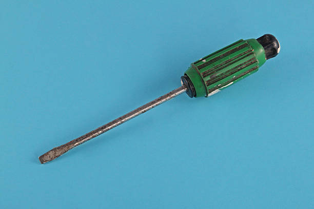 Green and black handeled screw driver. stock photo