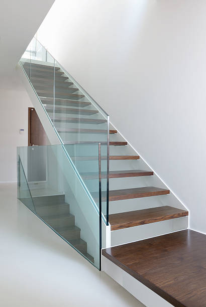 istock wooden stairs with glass balustrade 522712315