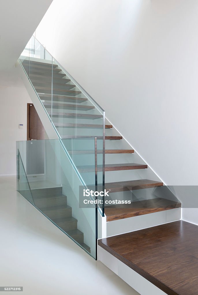 wooden stairs with glass balustrade wooden stairs with glass balustrade in modern interior and white epoxy flooring Glass - Material Stock Photo