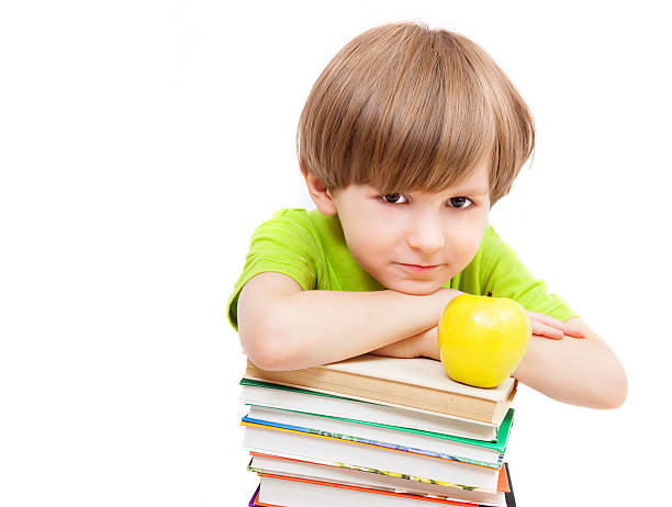 istock Preschooler with books and apple 522714407