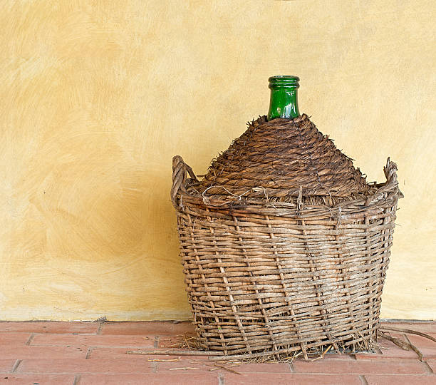 istock Old demijohn aka carboy for wine, wicker straw wrap. 522715079