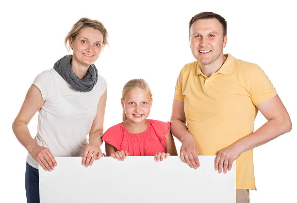 istock Happy Young Family Holding Banner 522718935