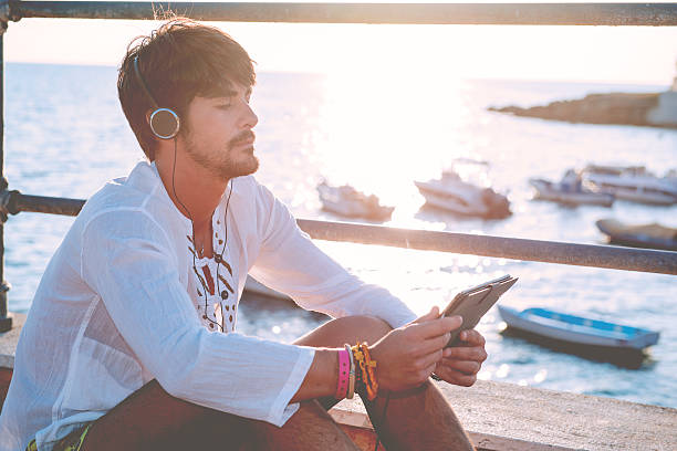 istock sitting by the sea reading a tablet in sunny afternoon 522724926