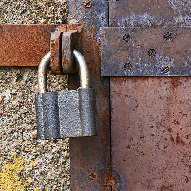 istock Old metal door closed with a lock 522725308