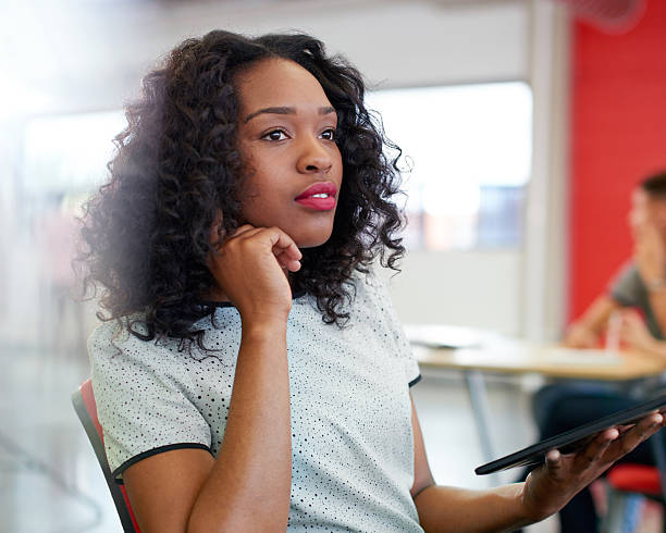 istock Confident female designer working on a digital tablet in red 522725468