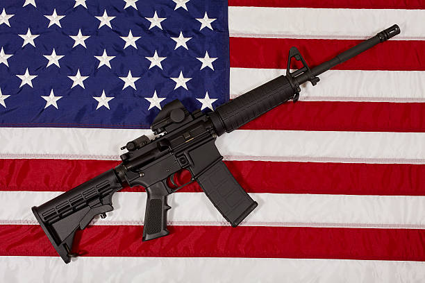 istock AR15 M4A1 M16 Style Weapon Automatic Rifle on USA Flag 522725996