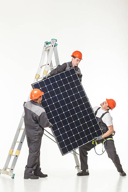 Man installing solar panels stock photo