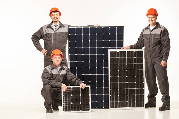 Happy smiling young men solar panel stock photo