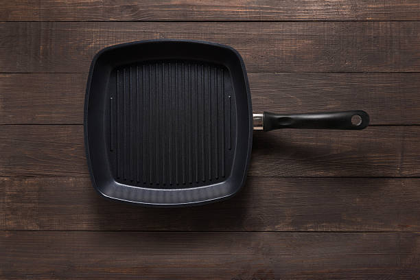istock Cast iron griddle pan on wooden background 522731042
