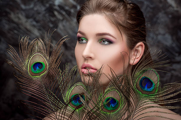 istock girl with bright  makeup and peacock feathe 522733086