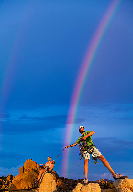 istock Husband and wife climbing team on the summit. 522734409