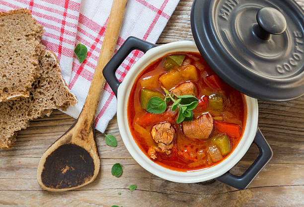 istock Goulash in a black cocotte with marjoram on rustic wood 522734818