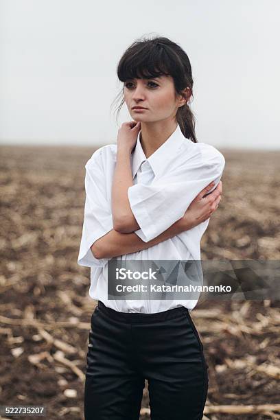 Girl In A White Shirt Standing In The Field Stock Photo - Download Image Now - Adult, Adults Only, Agricultural Field