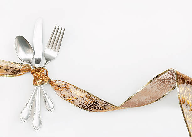 Silverware Wrapped with Holiday Gold Ribbon stock photo