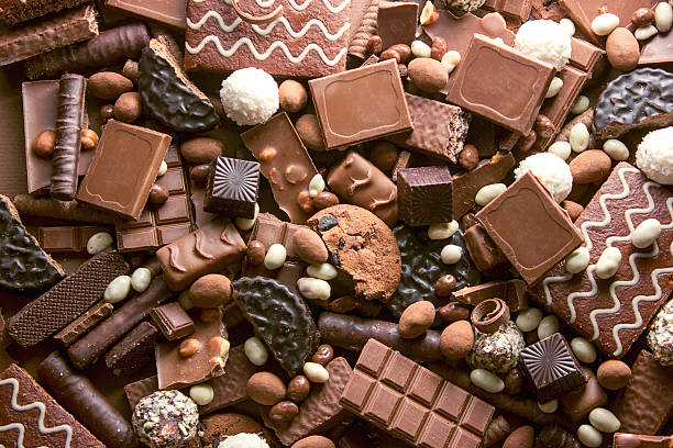 Chocolate background Chocolate background. Many pieces of chocolate, candies, cookies, biscuits, cakes and other sweets. Milk chocolate and dark chocolate. coconut candy mallow family stock pictures, royalty-free photos & images