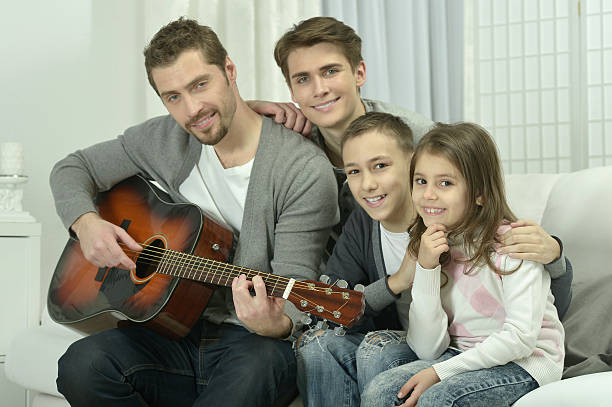 istock man playing the guitar for his family 522736006