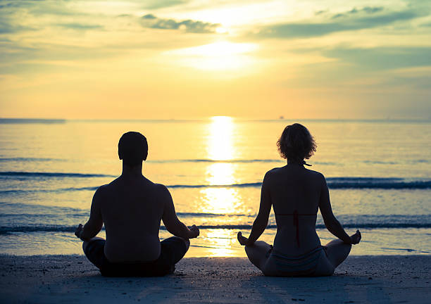 istock Young couple practicing yoga in the lotus position 522736361