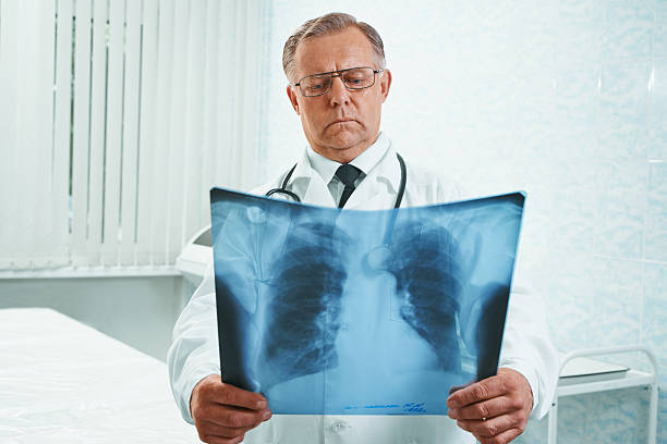 istock Adult doctor examines x-ray image 522736367