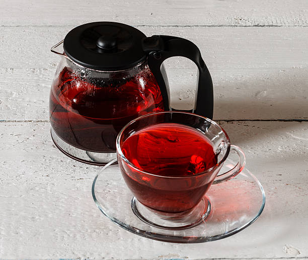 istock Cup of Karkadeh Red Tea and kettle on wooden table 522736482