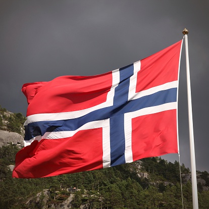 Flag of Norway - national symbol with nature in the background. Square composition.