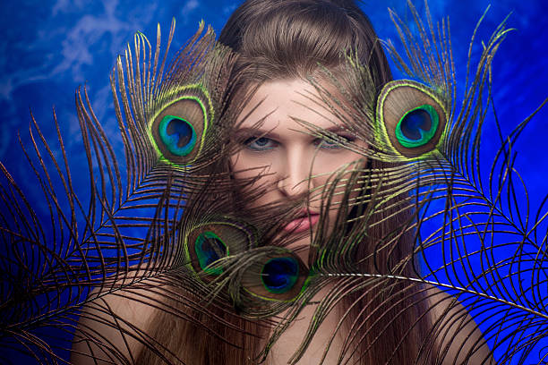 istock girl with bright  makeup and peacock feathe 522737094